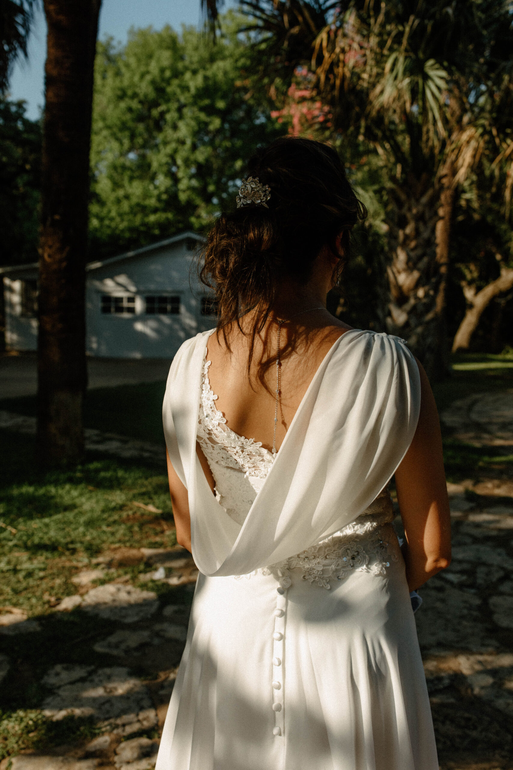 Wedding dress detail photo of white wedding dress cape. 