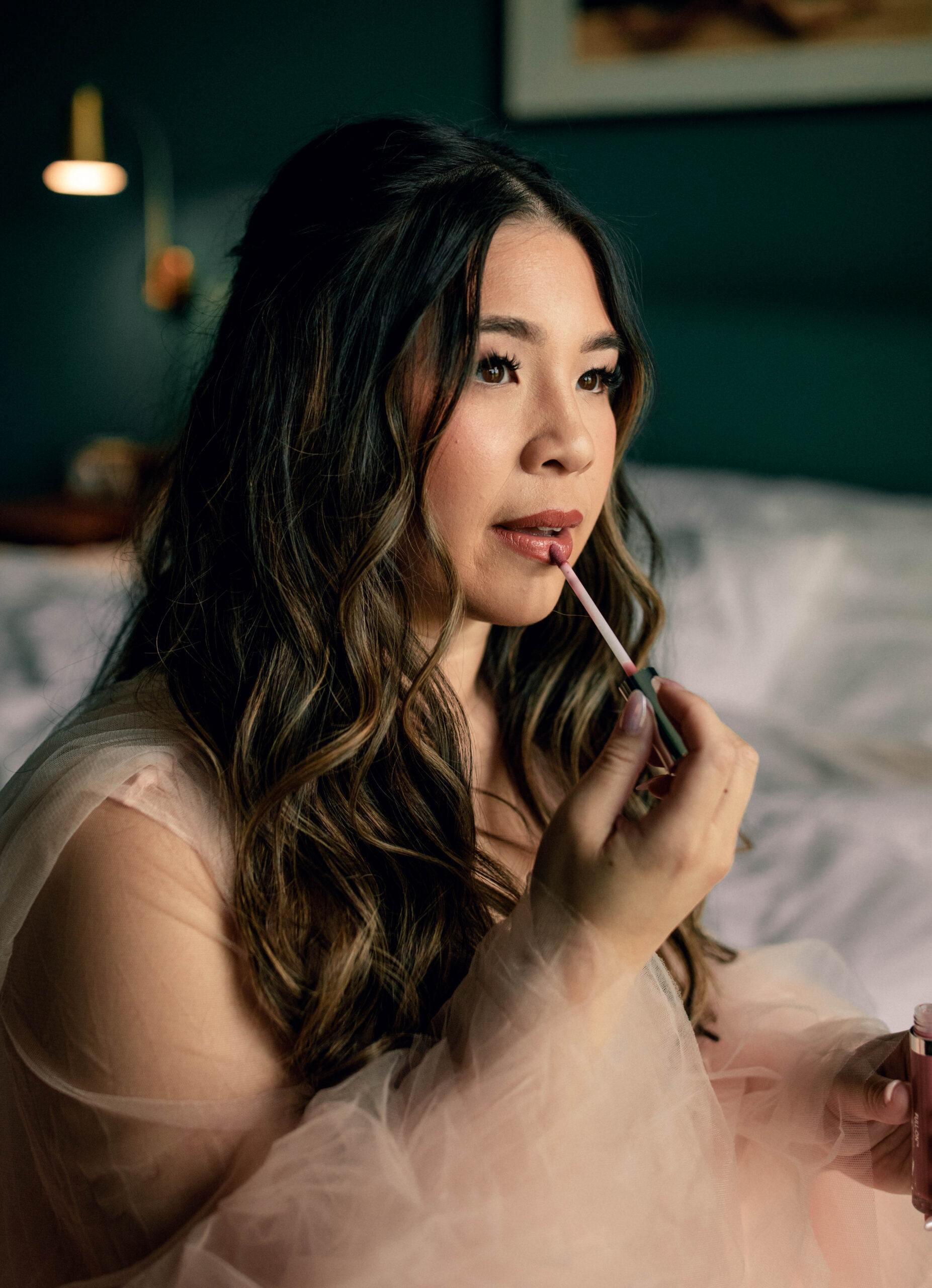 Bridal getting ready portrait applying lipgloss
