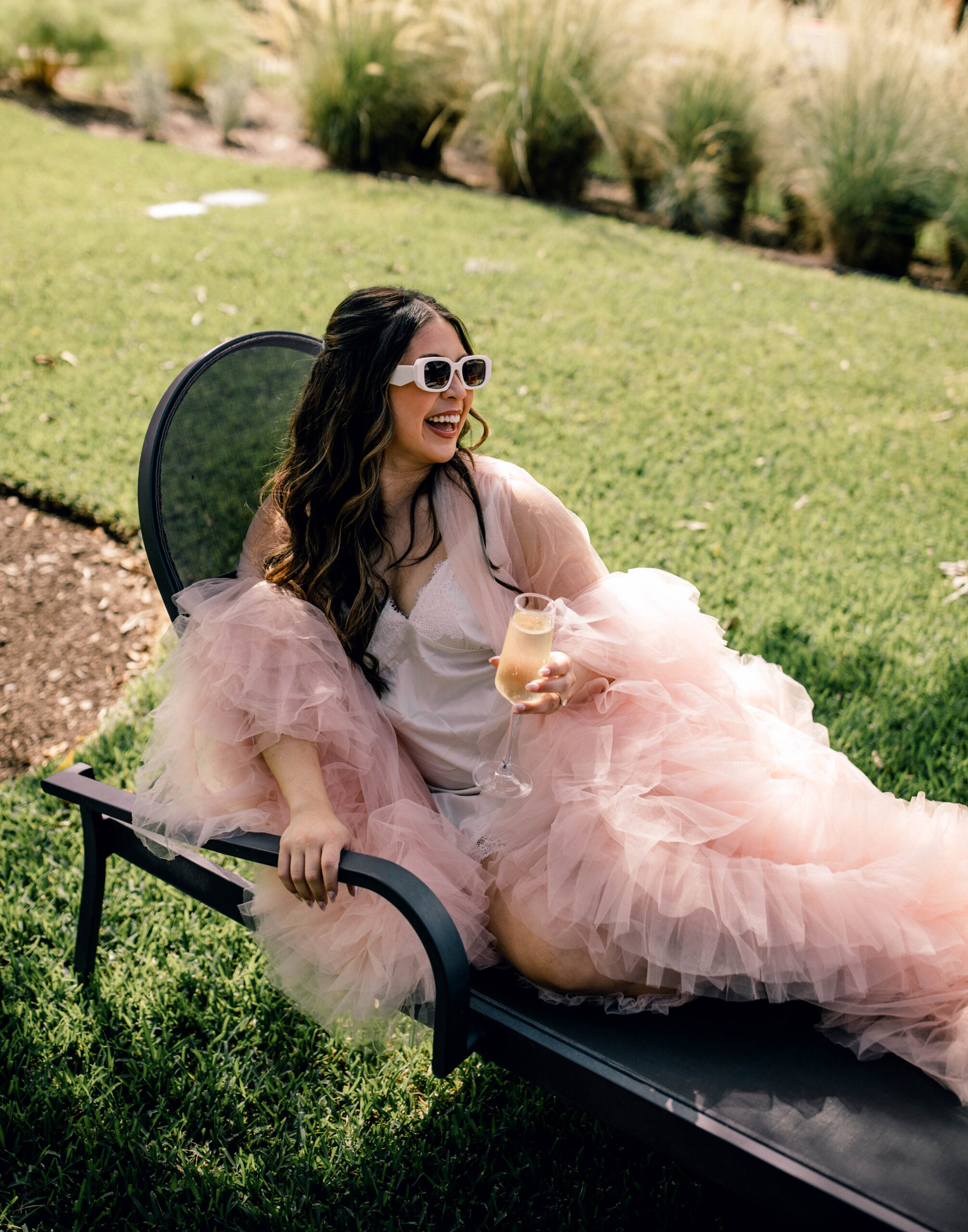 Poolside bridal photos in pink fluffy robe outside