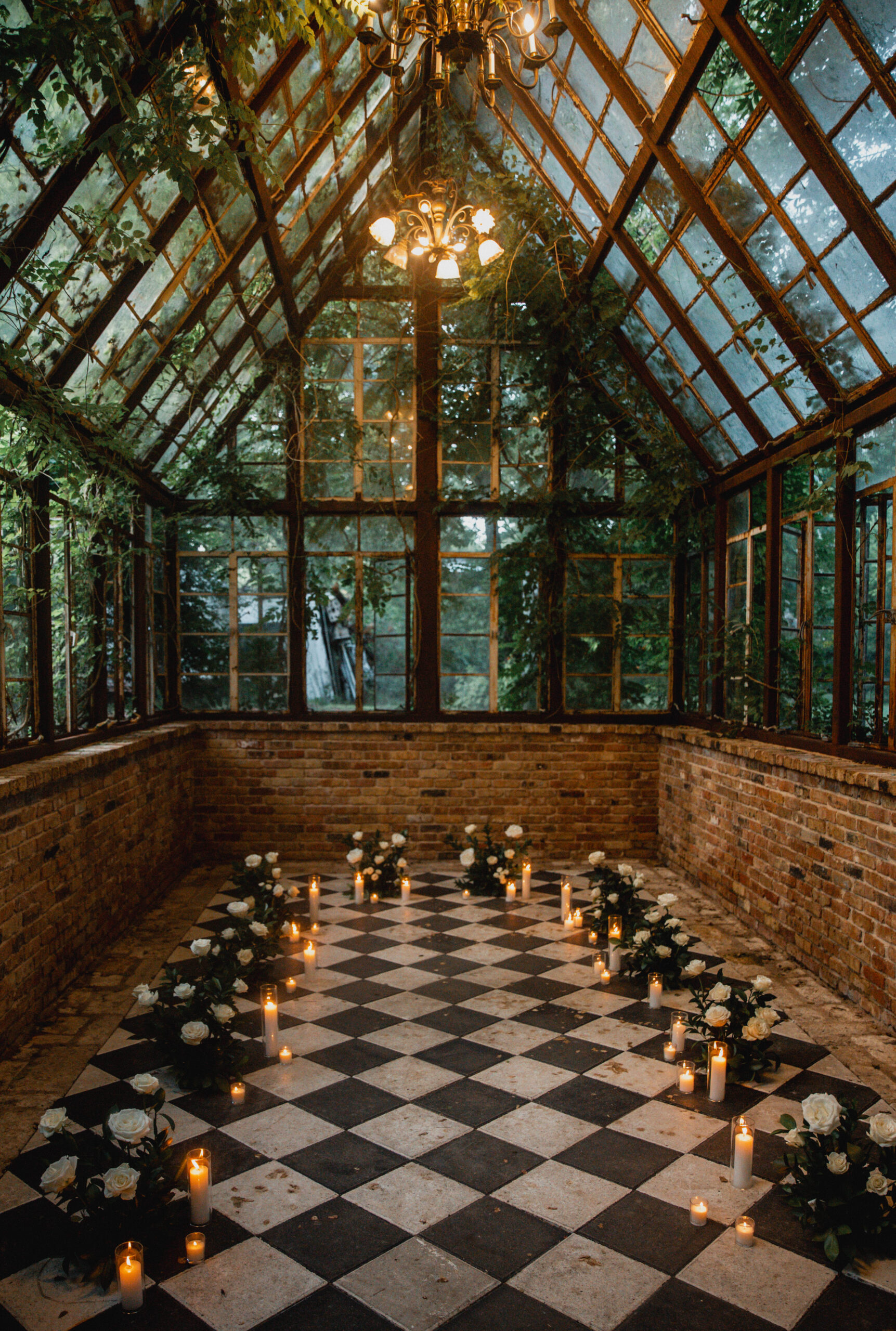 A photograph of the Sekrit Theater Greenhouse, decorated with flowers and candles for a proposal.