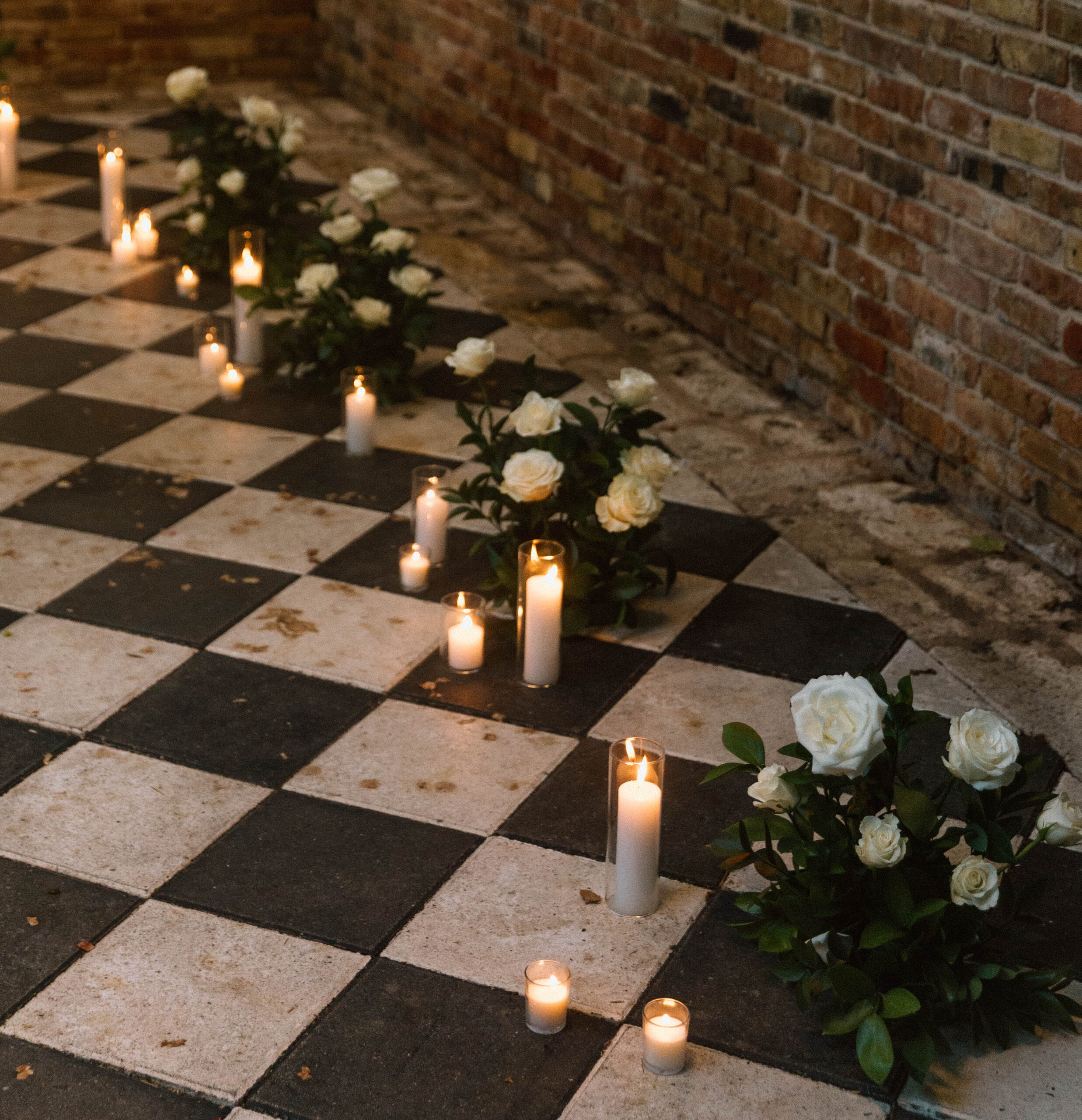 A photograph of the Sekrit Theater Greenhouse, decorated with flowers and candles for a proposal.