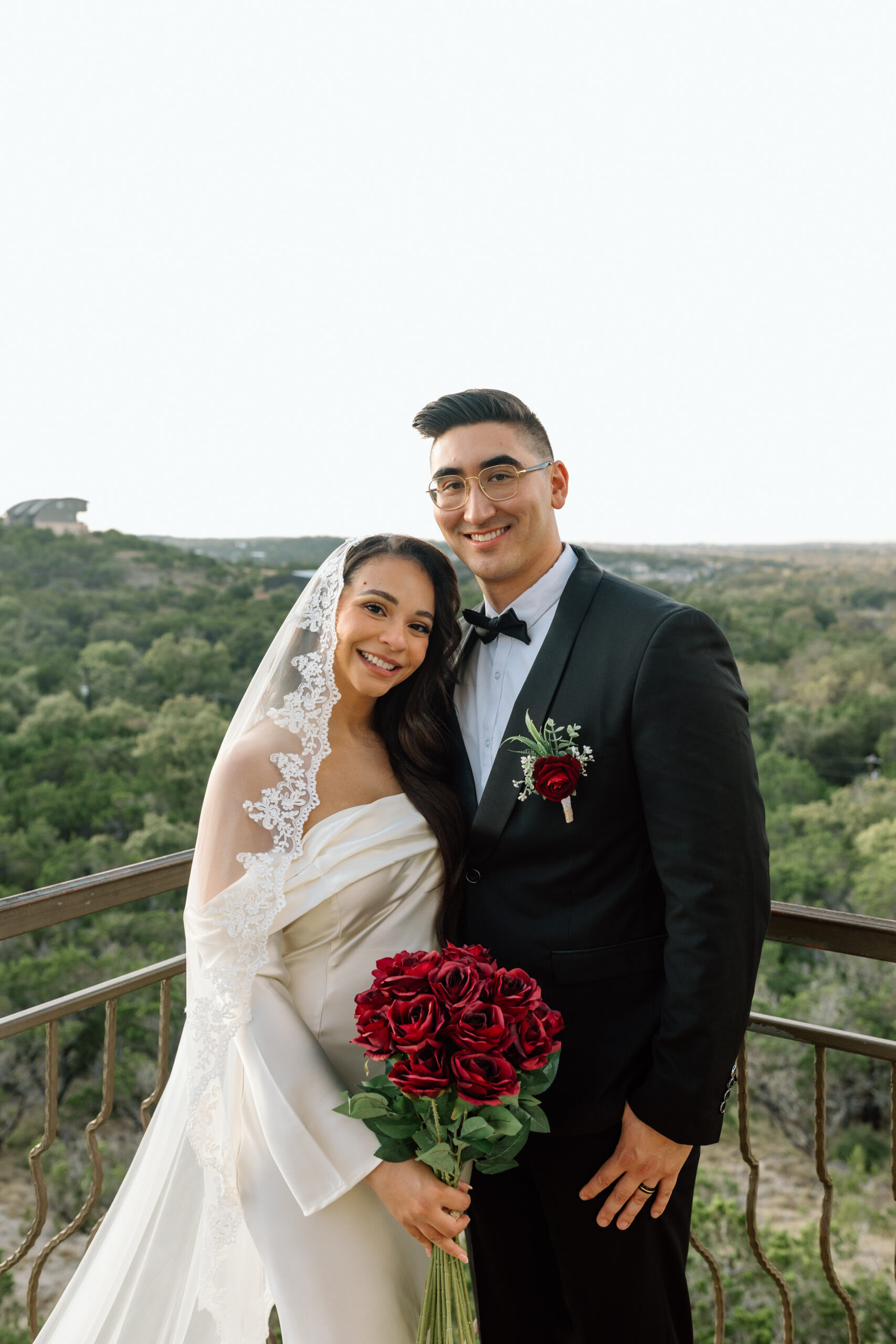 Wedding couple at Chapel Dulcinea on the balcony looking out over Texas Hill Country. 